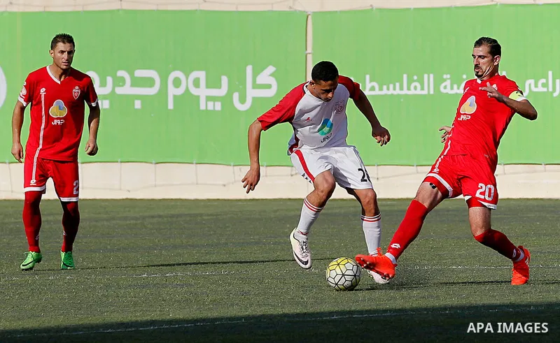 Ahly al-Khalil players and Shabab Khan Yunis players compete during thier a second leg match for the Palestinian Cup final on August 2, 2016 at Hussein Bin Ali Stadium in the West Bank city of Hebron. The match had origi...