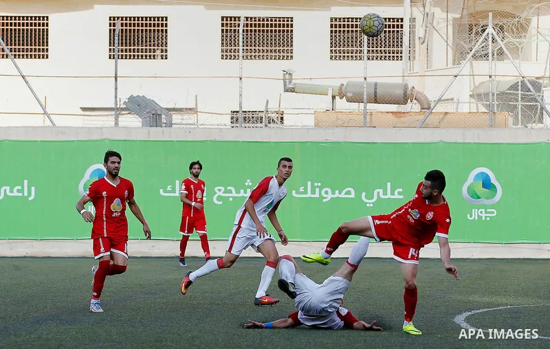 Ahly al-Khalil players and Shabab Khan Yunis players compete during thier a second leg match for the Palestinian Cup final on August 2, 2016 at Hussein Bin Ali Stadium in the West Bank city of Hebron. The match had origi...