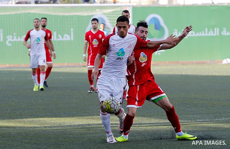 Ahly al-Khalil players and Shabab Khan Yunis players compete during thier a second leg match for the Palestinian Cup final on August 2, 2016 at Hussein Bin Ali Stadium in the West Bank city of Hebron. The match had origi...