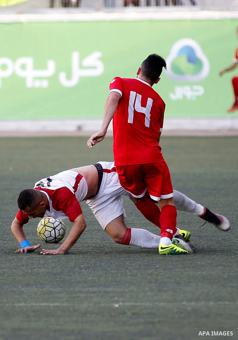 Ahly al-Khalil players and Shabab Khan Yunis players compete during thier a second leg match for the Palestinian Cup final on August 2, 2016 at Hussein Bin Ali Stadium in the West Bank city of Hebron. The match had origi...