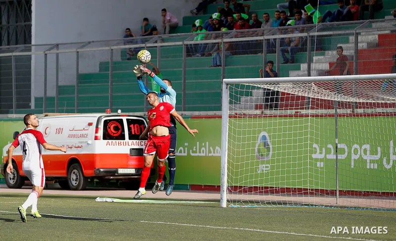 Ahly al-Khalil players and Shabab Khan Yunis players compete during thier a second leg match for the Palestinian Cup final on August 2, 2016 at Hussein Bin Ali Stadium in the West Bank city of Hebron. The match had origi...