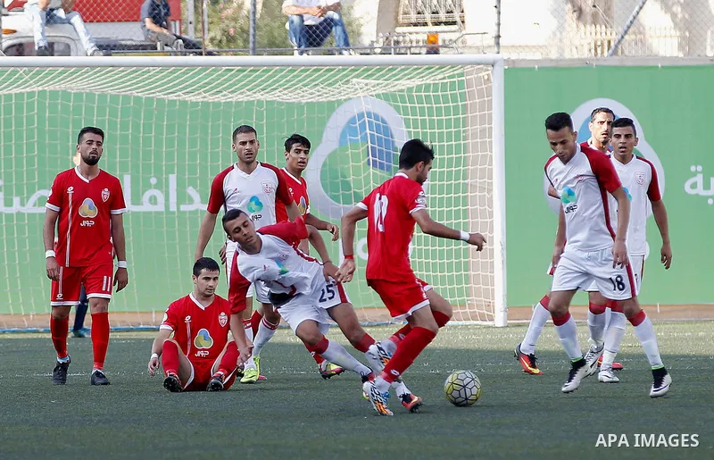Ahly al-Khalil players and Shabab Khan Yunis players compete during thier a second leg match for the Palestinian Cup final on August 2, 2016 at Hussein Bin Ali Stadium in the West Bank city of Hebron. The match had origi...