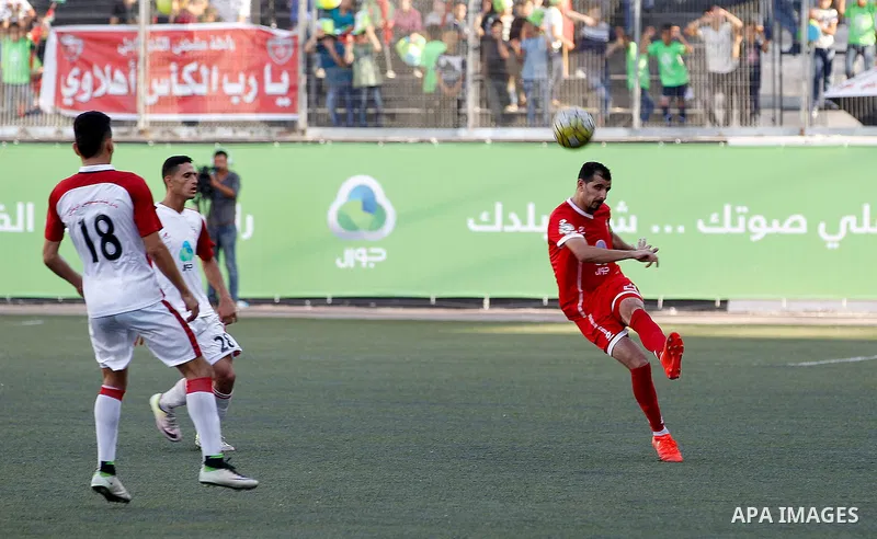 Ahly al-Khalil players and Shabab Khan Yunis players compete during thier a second leg match for the Palestinian Cup final on August 2, 2016 at Hussein Bin Ali Stadium in the West Bank city of Hebron. The match had origi...