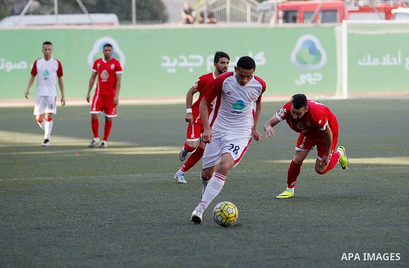 Ahly al-Khalil players and Shabab Khan Yunis players compete during thier a second leg match for the Palestinian Cup final on August 2, 2016 at Hussein Bin Ali Stadium in the West Bank city of Hebron. The match had origi...
