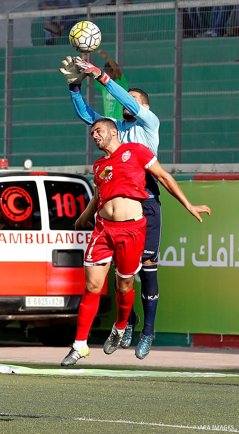 Ahly al-Khalil players and Shabab Khan Yunis players compete during thier a second leg match for the Palestinian Cup final on August 2, 2016 at Hussein Bin Ali Stadium in the West Bank city of Hebron. The match had origi...