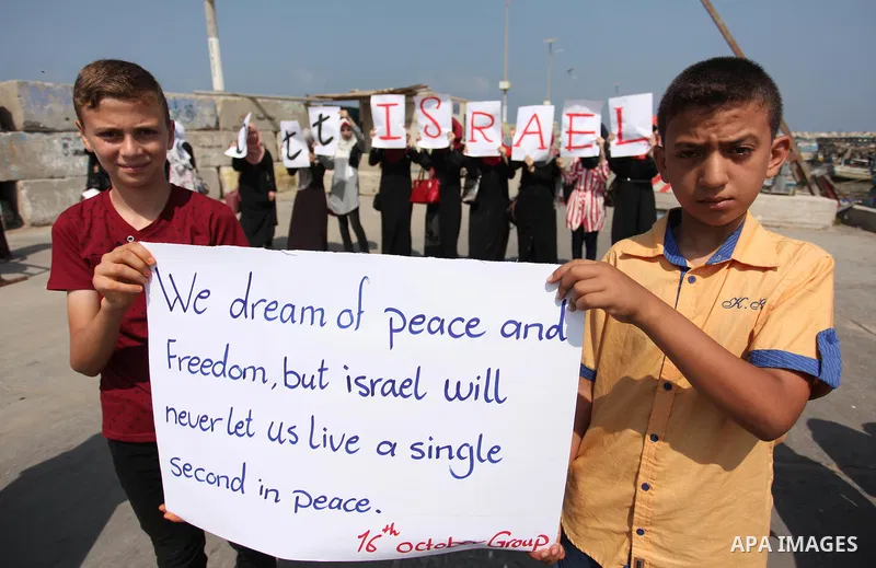 Palestinian girls hold banners during a protest to mark the second anniversary of the 50-day Israeli war on Gaza Strip last summer, in Gaza seaport Aug. 03, 2016. July 8th marks the two-year anniversary of the war betwee...
