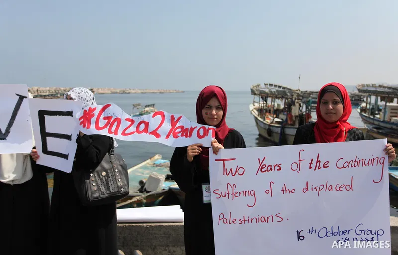 Palestinian girls hold banners during a protest to mark the second anniversary of the 50-day Israeli war on Gaza Strip last summer, in Gaza seaport Aug. 03, 2016. July 8th marks the two-year anniversary of the war betwee...