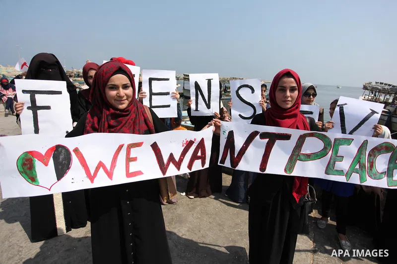 Palestinian girls hold banners during a protest to mark the second anniversary of the 50-day Israeli war on Gaza Strip last summer, in Gaza seaport Aug. 03, 2016. July 8th marks the two-year anniversary of the war betwee...