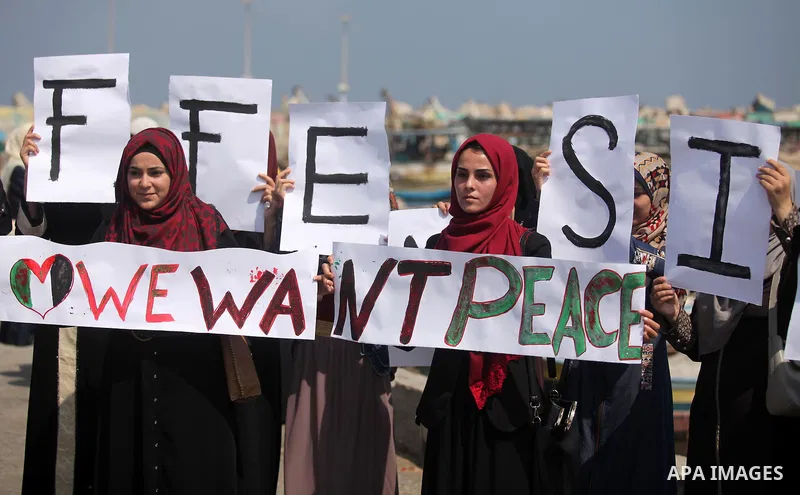 Palestinian girls hold banners during a protest to mark the second anniversary of the 50-day Israeli war on Gaza Strip last summer, in Gaza seaport Aug. 03, 2016. July 8th marks the two-year anniversary of the war betwee...