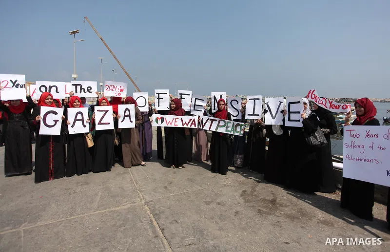 Palestinian girls hold banners during a protest to mark the second anniversary of the 50-day Israeli war on Gaza Strip last summer, in Gaza seaport Aug. 03, 2016. July 8th marks the two-year anniversary of the war betwee...