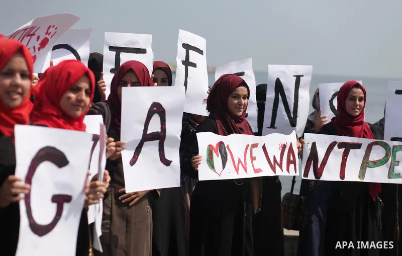 Palestinian girls hold banners during a protest to mark the second anniversary of the 50-day Israeli war on Gaza Strip last summer, in Gaza seaport Aug. 03, 2016. July 8th marks the two-year anniversary of the war betwee...