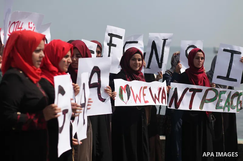 Palestinian girls hold banners during a protest to mark the second anniversary of the 50-day Israeli war on Gaza Strip last summer, in Gaza seaport Aug. 03, 2016. July 8th marks the two-year anniversary of the war betwee...