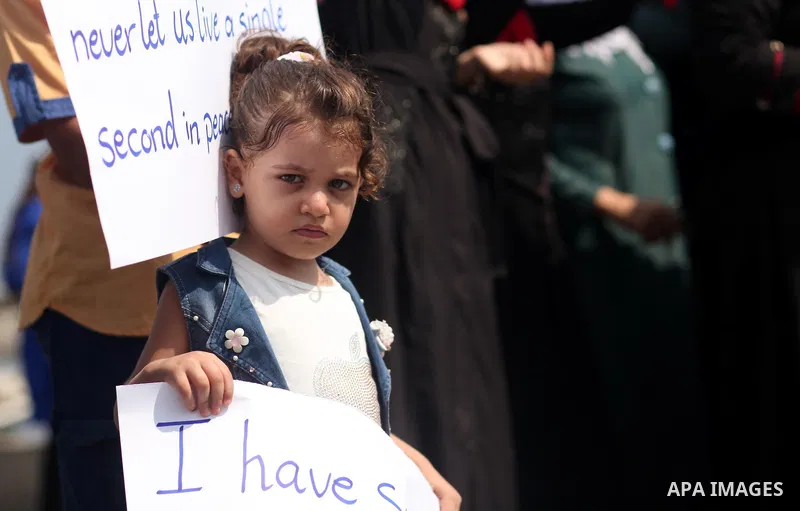 Palestinian girls hold banners during a protest to mark the second anniversary of the 50-day Israeli war on Gaza Strip last summer, in Gaza seaport Aug. 03, 2016. July 8th marks the two-year anniversary of the war betwee...