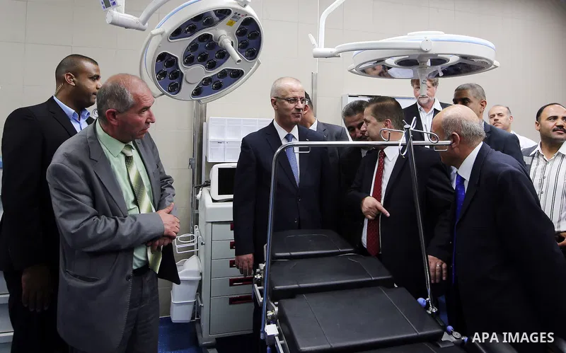 Palestinian Prime Minister Rami Hamdallah attends the opening ceremony of the new wing operations of Alia governmental hospital, in the West Bank city of Hebron, on Aug. 03, 2016. Photo by Prime Minister Office