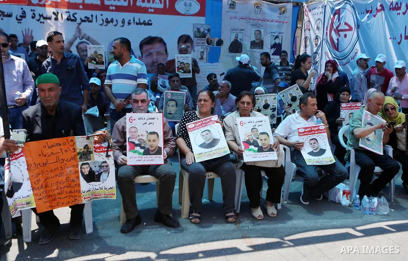 Palestinians take part in a protest demanding for the release of Bilal Kayed a Palestinian prisoner on hunger strike, in the West Bank city Ramallah on Aug. 03, 2016. Kayed who was due to be released after serving a 14-a...