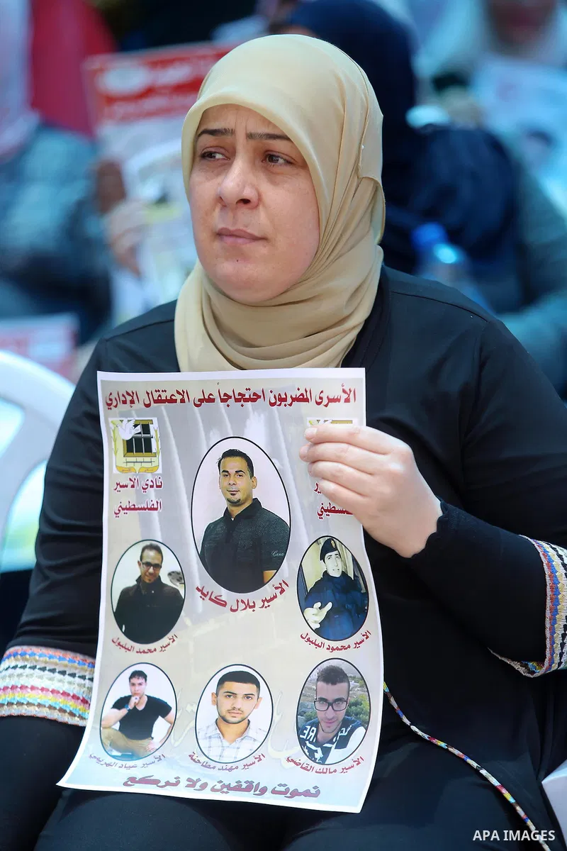 Palestinians take part in a protest demanding for the release of Bilal Kayed a Palestinian prisoner on hunger strike, in the West Bank city Ramallah on Aug. 03, 2016. Kayed who was due to be released after serving a 14-a...