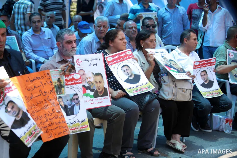 Palestinians take part in a protest demanding for the release of Bilal Kayed a Palestinian prisoner on hunger strike, in the West Bank city Ramallah on Aug. 03, 2016. Kayed who was due to be released after serving a 14-a...