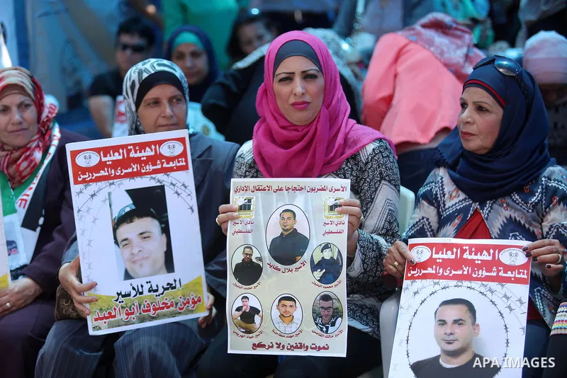 Palestinians take part in a protest demanding for the release of Bilal Kayed a Palestinian prisoner on hunger strike, in the West Bank city Ramallah on Aug. 03, 2016. Kayed who was due to be released after serving a 14-a...