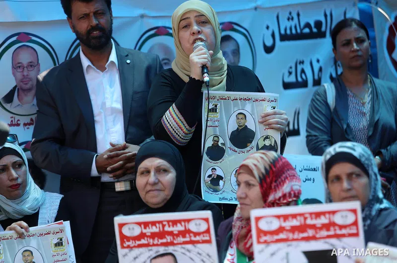 Palestinians take part in a protest demanding for the release of Bilal Kayed a Palestinian prisoner on hunger strike, in the West Bank city Ramallah on Aug. 03, 2016. Kayed who was due to be released after serving a 14-a...