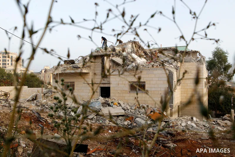 Palestinians inspect the damage after Israeli troops demolished the family house of Palestinian assailant Khalid Makhamreh in the West Bank village of Yatta, south of Hebron August 4, 2016. Photo by Wisam Hashlamoun