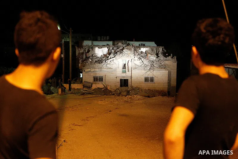 Palestinians inspect the damage after Israeli troops demolished the family house of Palestinian assailant Khalid Makhamreh in the West Bank village of Yatta, south of Hebron August 4, 2016. Photo by Wisam Hashlamoun
