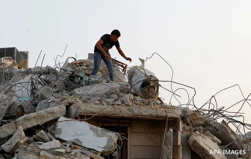 Palestinians inspect the damage after Israeli troops demolished the family house of Palestinian assailant Khalid Makhamreh in the West Bank village of Yatta, south of Hebron August 4, 2016. Photo by Wisam Hashlamoun