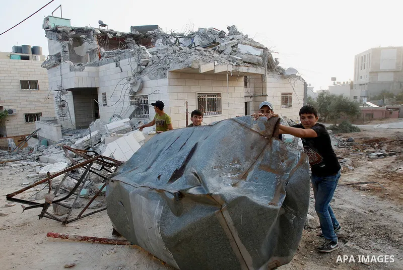 Palestinians inspect the damage after Israeli troops demolished the family house of Palestinian assailant Khalid Makhamreh in the West Bank village of Yatta, south of Hebron August 4, 2016. Photo by Wisam Hashlamoun