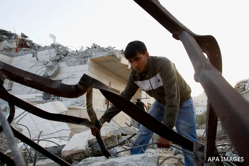 Palestinians inspect the damage after Israeli troops demolished the family house of Palestinian assailant Khalid Makhamreh in the West Bank village of Yatta, south of Hebron August 4, 2016. Photo by Wisam Hashlamoun