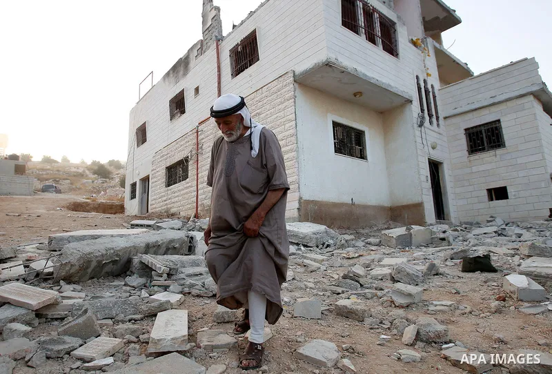Relatives inspect the family house of Palestinian assailant Mohammad Makhamreh after it was partially blown up by Israeli troops in the West Bank village of Yatta, south of Hebron August 4, 2016. Photo by Wisam Hashlamou...