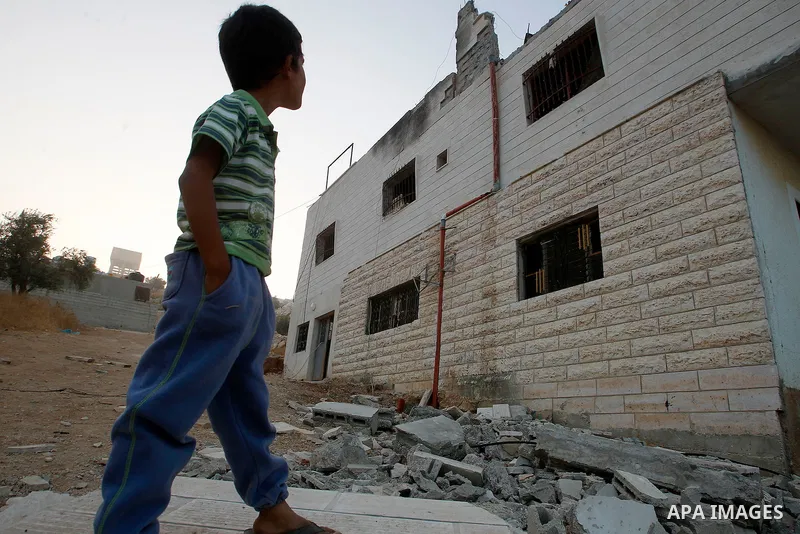 Relatives inspect the family house of Palestinian assailant Mohammad Makhamreh after it was partially blown up by Israeli troops in the West Bank village of Yatta, south of Hebron August 4, 2016. Photo by Wisam Hashlamou...