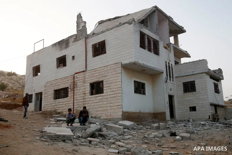 Relatives inspect the family house of Palestinian assailant Mohammad Makhamreh after it was partially blown up by Israeli troops in the West Bank village of Yatta, south of Hebron August 4, 2016. Photo by Wisam Hashlamou...