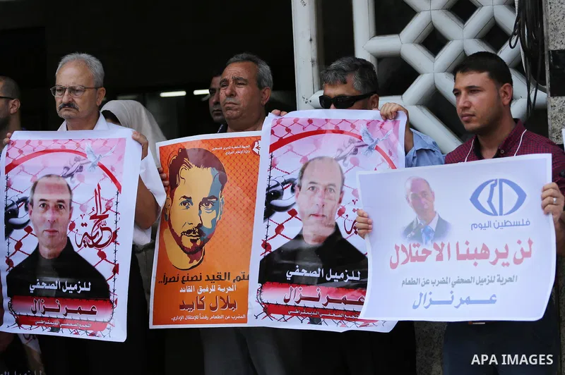 Palestinian journalists take part during a protest calling for the release of Palestinian journalist Omar Nazal who is on hunger strike in Gaza city on Aug. 04, 2016. Photo by Mohammed Asad