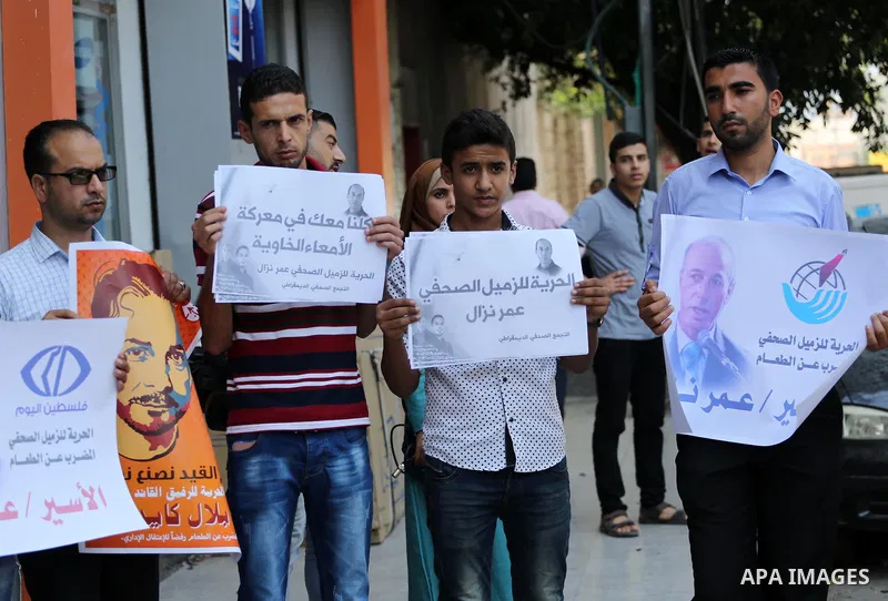 Palestinian journalists take part during a protest calling for the release of Palestinian journalist Omar Nazal who is on hunger strike in Gaza city on Aug. 04, 2016. Photo by Mohammed Asad