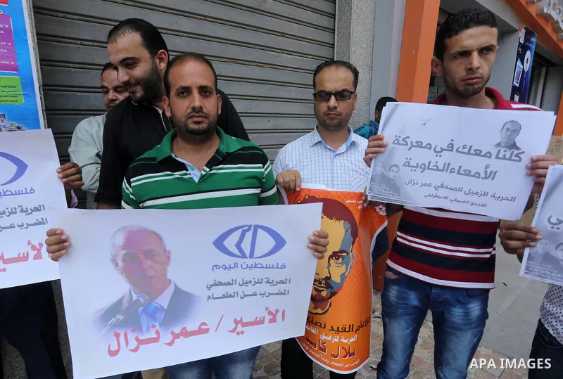 Palestinian journalists take part during a protest calling for the release of Palestinian journalist Omar Nazal who is on hunger strike in Gaza city on Aug. 04, 2016. Photo by Mohammed Asad