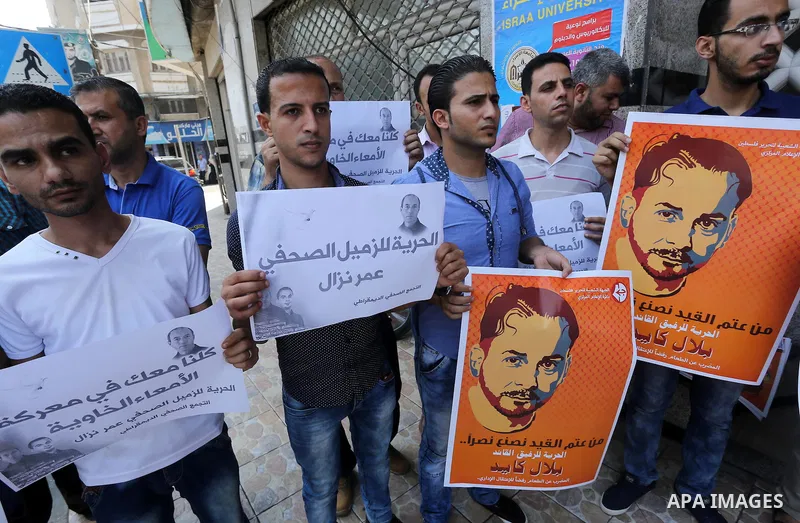 Palestinian journalists take part during a protest calling for the release of Palestinian journalist Omar Nazal who is on hunger strike in Gaza city on Aug. 04, 2016. Photo by Mohammed Asad