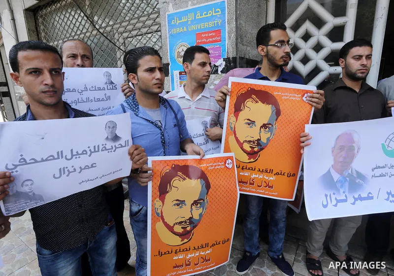 Palestinian journalists take part during a protest calling for the release of Palestinian journalist Omar Nazal who is on hunger strike in Gaza city on Aug. 04, 2016. Photo by Mohammed Asad