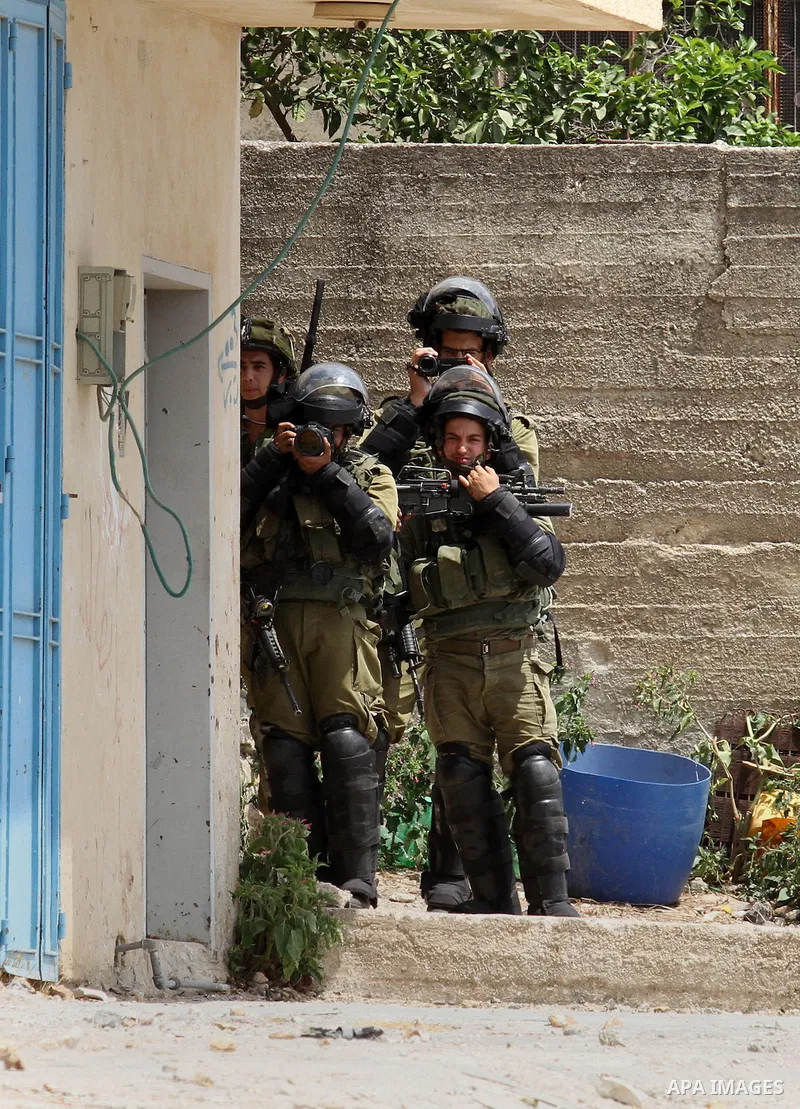 Israeli security forces take pictures during clashes with Palestinian protesters following the weekly demonstration against the expropriation of Palestinian land by Israel in the village of Kfar Qaddum, near Nablus, in t...