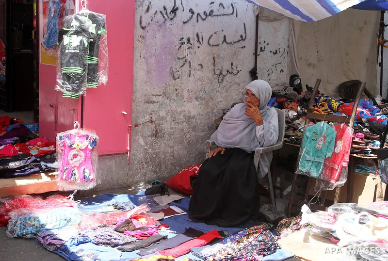 Palestinians shop during preparation for the new school year at a market in Rafah in the southern Gaza strip on Aug 6, 2016. Photo by Abed Rahim Khatib