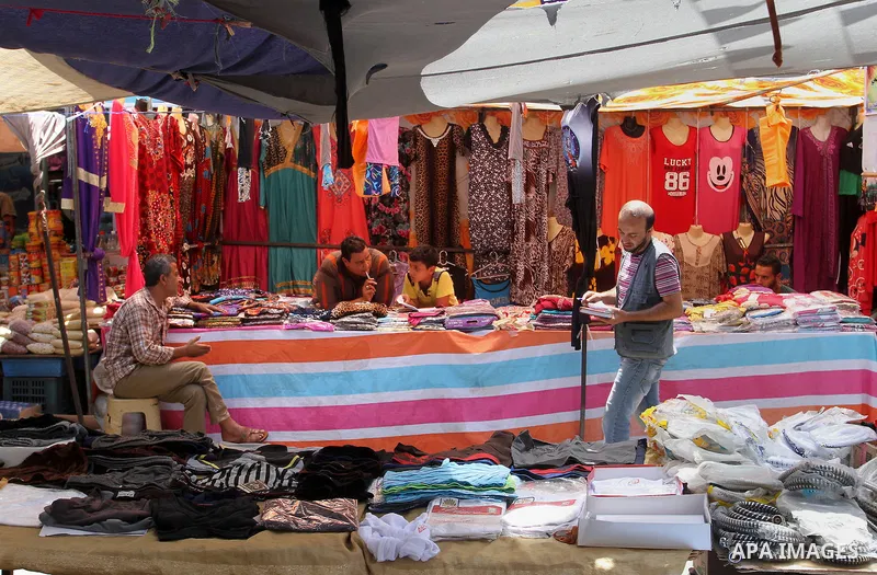 Palestinians shop during preparation for the new school year at a market in Rafah in the southern Gaza strip on Aug 6, 2016. Photo by Abed Rahim Khatib