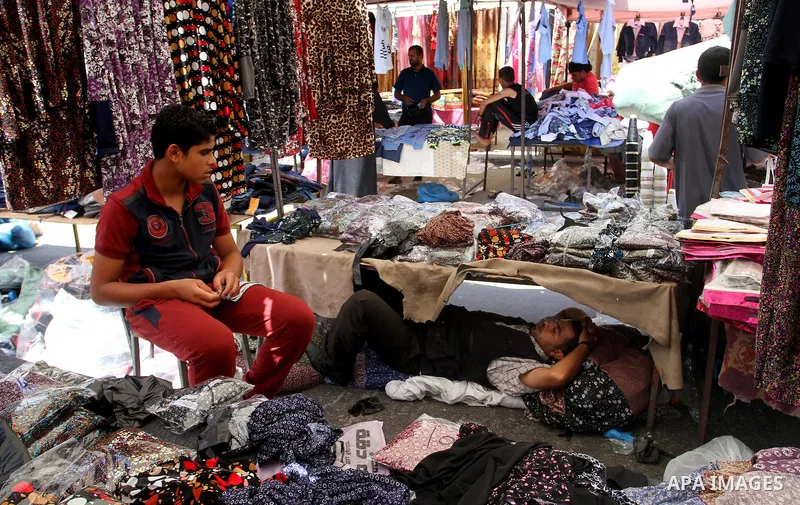 Palestinians shop during preparation for the new school year at a market in Rafah in the southern Gaza strip on Aug 6, 2016. Photo by Abed Rahim Khatib