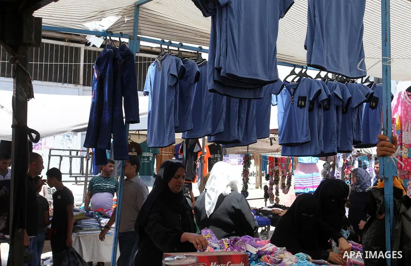 Palestinians shop during preparation for the new school year at a market in Rafah in the southern Gaza strip on Aug 6, 2016. Photo by Abed Rahim Khatib