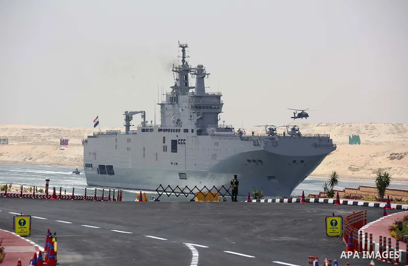 The Mistral-class helicopter carrier Gamal Abdel Nasser (ex-Vladivostok) crosses the new section of the Suez Canal during the first anniversary of launching the New Suez Canal and the 60th anniversary of nationalizing th...