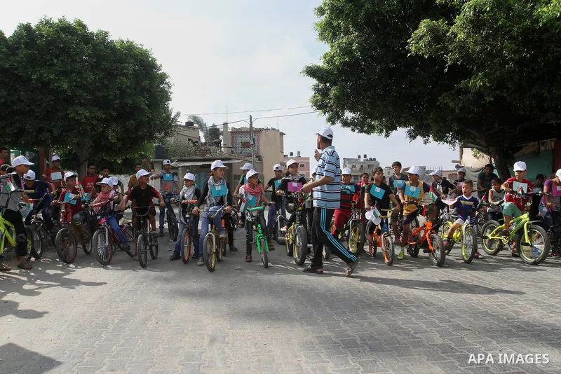 Palestinian children take part in the bicycles marathon to demand their right to play and break the siege on Gaza strip, in Rafah in the southern Gaza Strip. on August 7, 2016. Photo by Abed Rahim Khatib