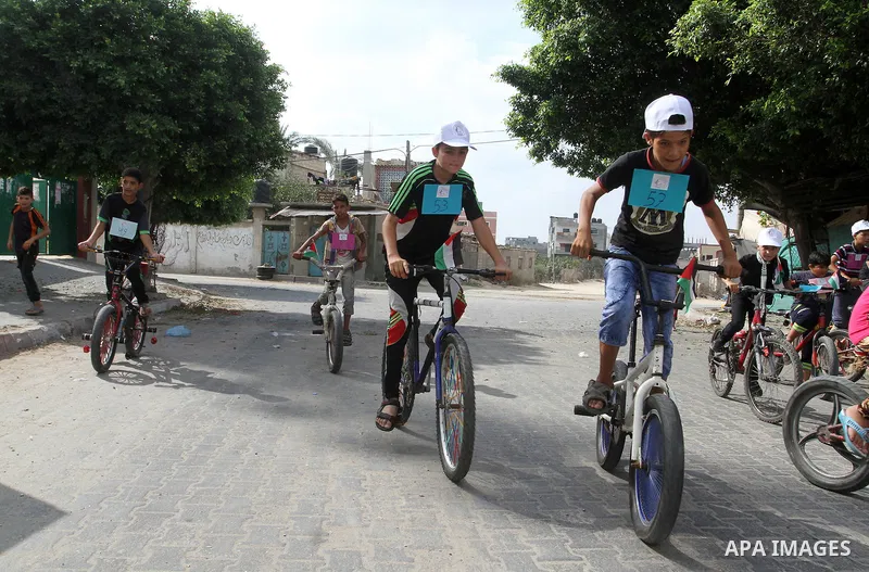 Palestinian children take part in the bicycles marathon to demand their right to play and break the siege on Gaza strip, in Rafah in the southern Gaza Strip. on August 7, 2016. Photo by Abed Rahim Khatib