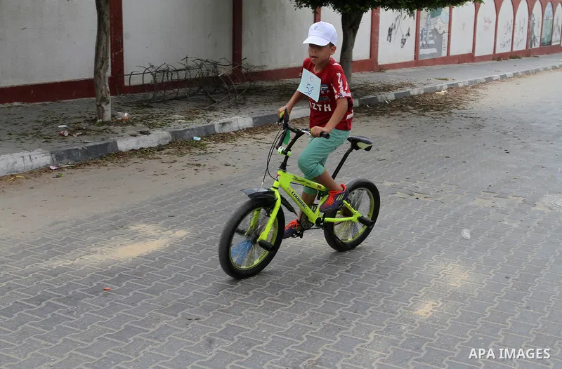 Palestinian children take part in the bicycles marathon to demand their right to play and break the siege on Gaza strip, in Rafah in the southern Gaza Strip. on August 7, 2016. Photo by Abed Rahim Khatib