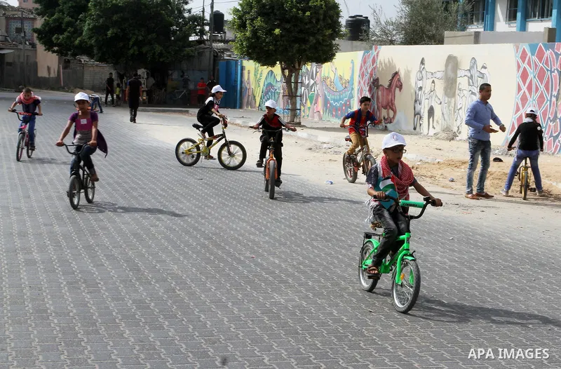 Palestinian children take part in the bicycles marathon to demand their right to play and break the siege on Gaza strip, in Rafah in the southern Gaza Strip. on August 7, 2016. Photo by Abed Rahim Khatib