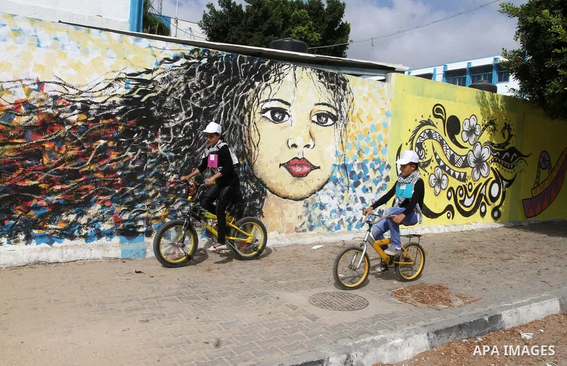 Palestinian children take part in the bicycles marathon to demand their right to play and break the siege on Gaza strip, in Rafah in the southern Gaza Strip. on August 7, 2016. Photo by Abed Rahim Khatib