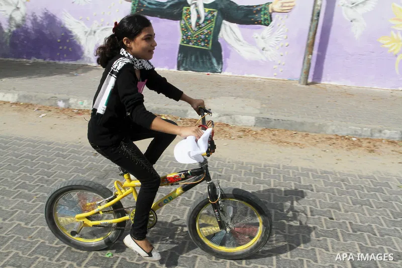 Palestinian children take part in the bicycles marathon to demand their right to play and break the siege on Gaza strip, in Rafah in the southern Gaza Strip. on August 7, 2016. Photo by Abed Rahim Khatib