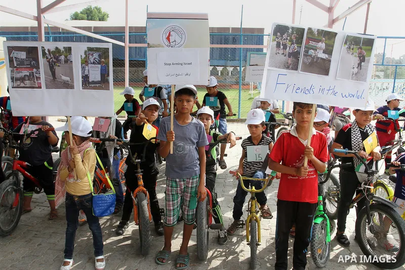 Palestinian children take part in the bicycles marathon to demand their right to play and break the siege on Gaza strip, in Rafah in the southern Gaza Strip. on August 7, 2016. Photo by Abed Rahim Khatib