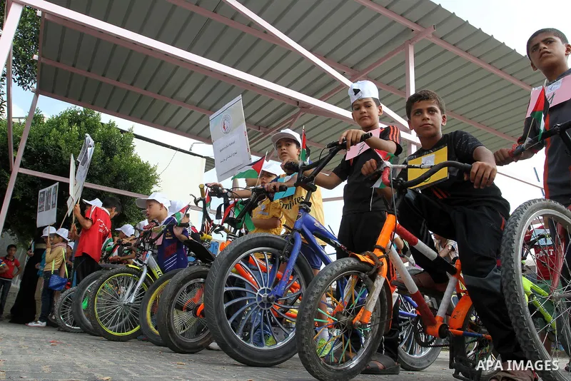 Palestinian children take part in the bicycles marathon to demand their right to play and break the siege on Gaza strip, in Rafah in the southern Gaza Strip. on August 7, 2016. Photo by Abed Rahim Khatib